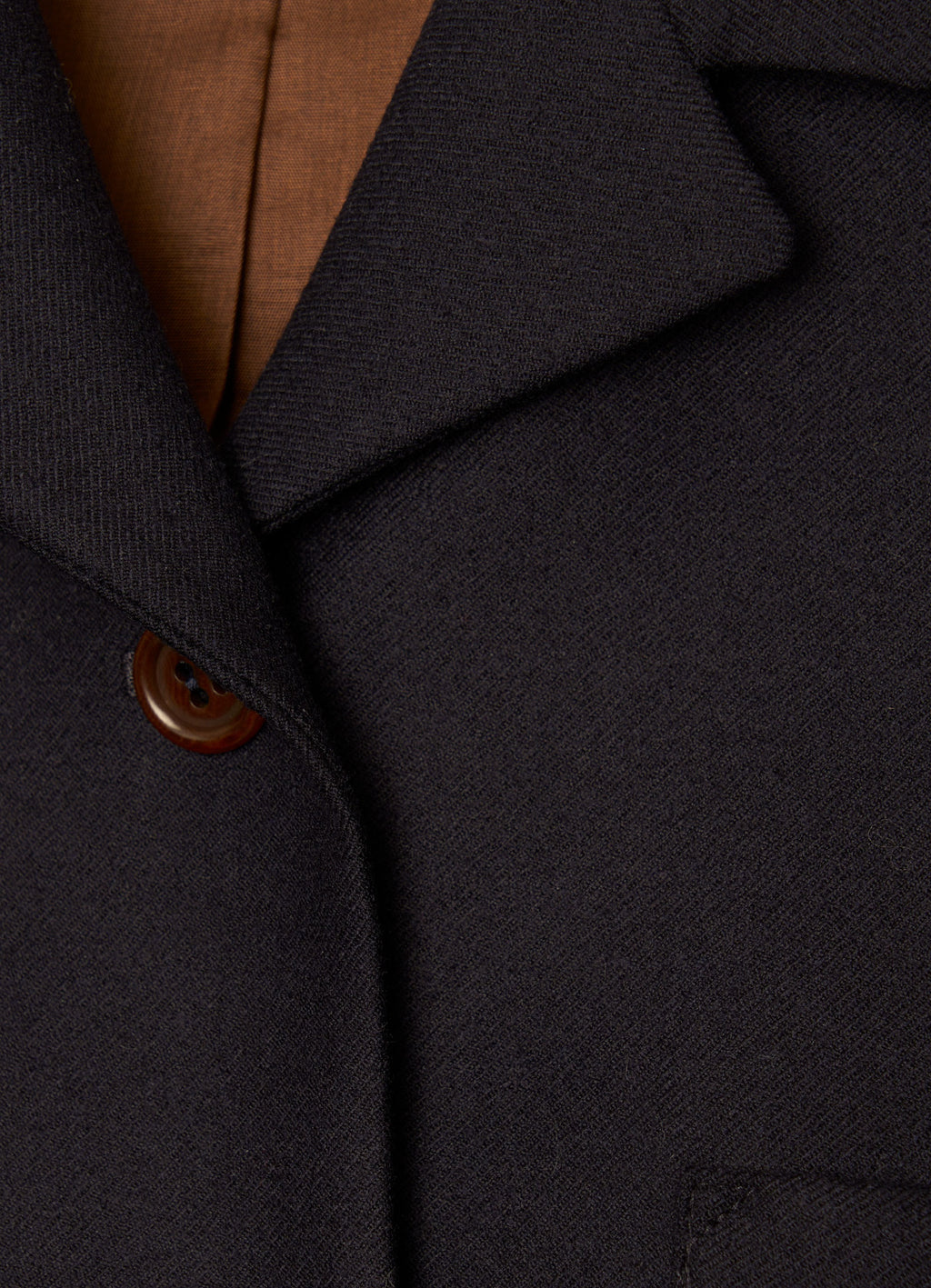 Close-up of black wool cropped jacket and lapel