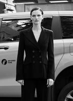 Model Sophie Grace Hirsch wearing SCHOENBACH double breasted blazer in front of the a New York City yellow cab