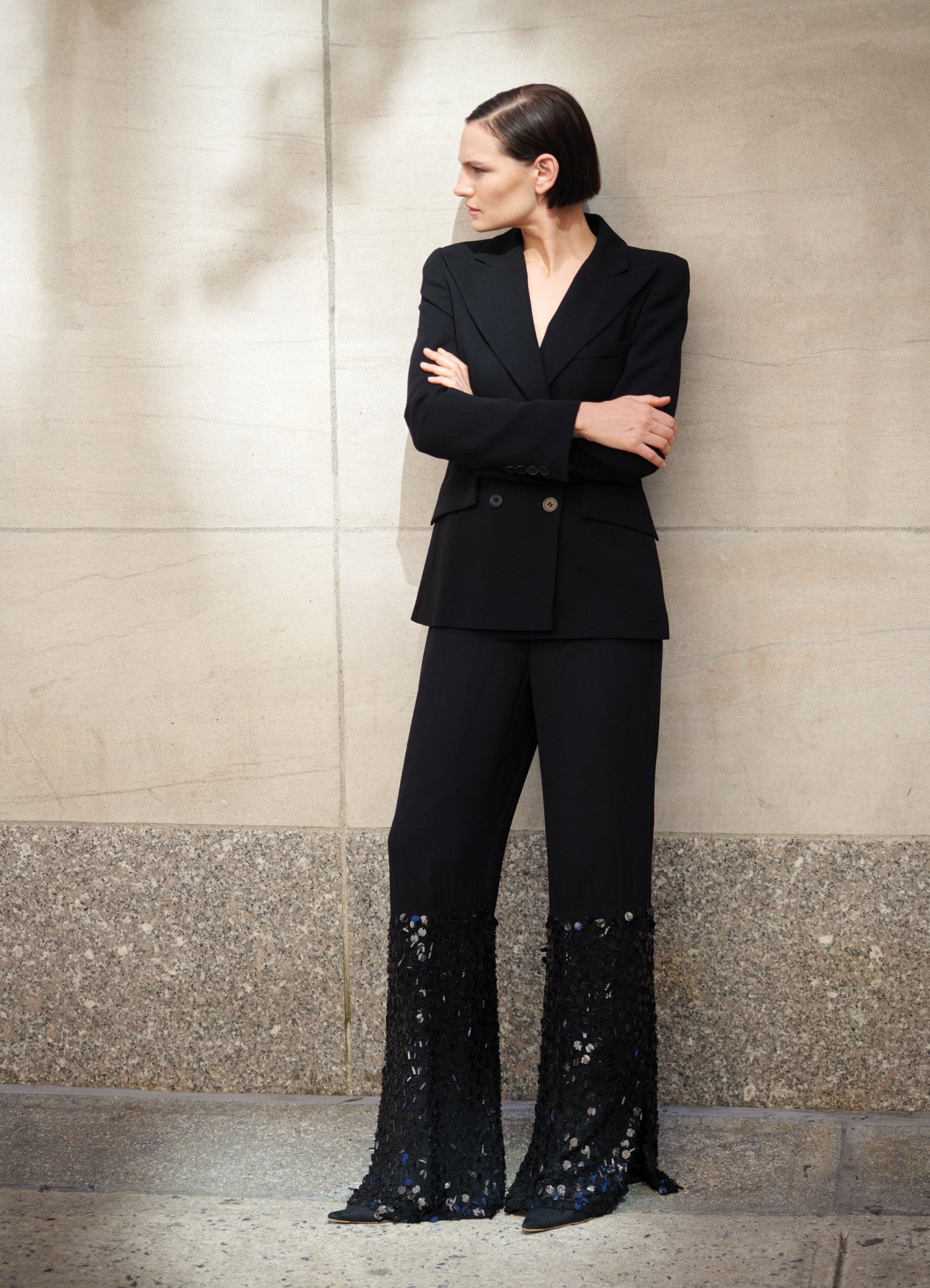 Model Sophie Grace Hirsch wearing SCHOENBACH double breasted blazer in front of a wall in NYC