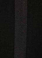 Close-up of black wool smoking trousers with satin side stripe