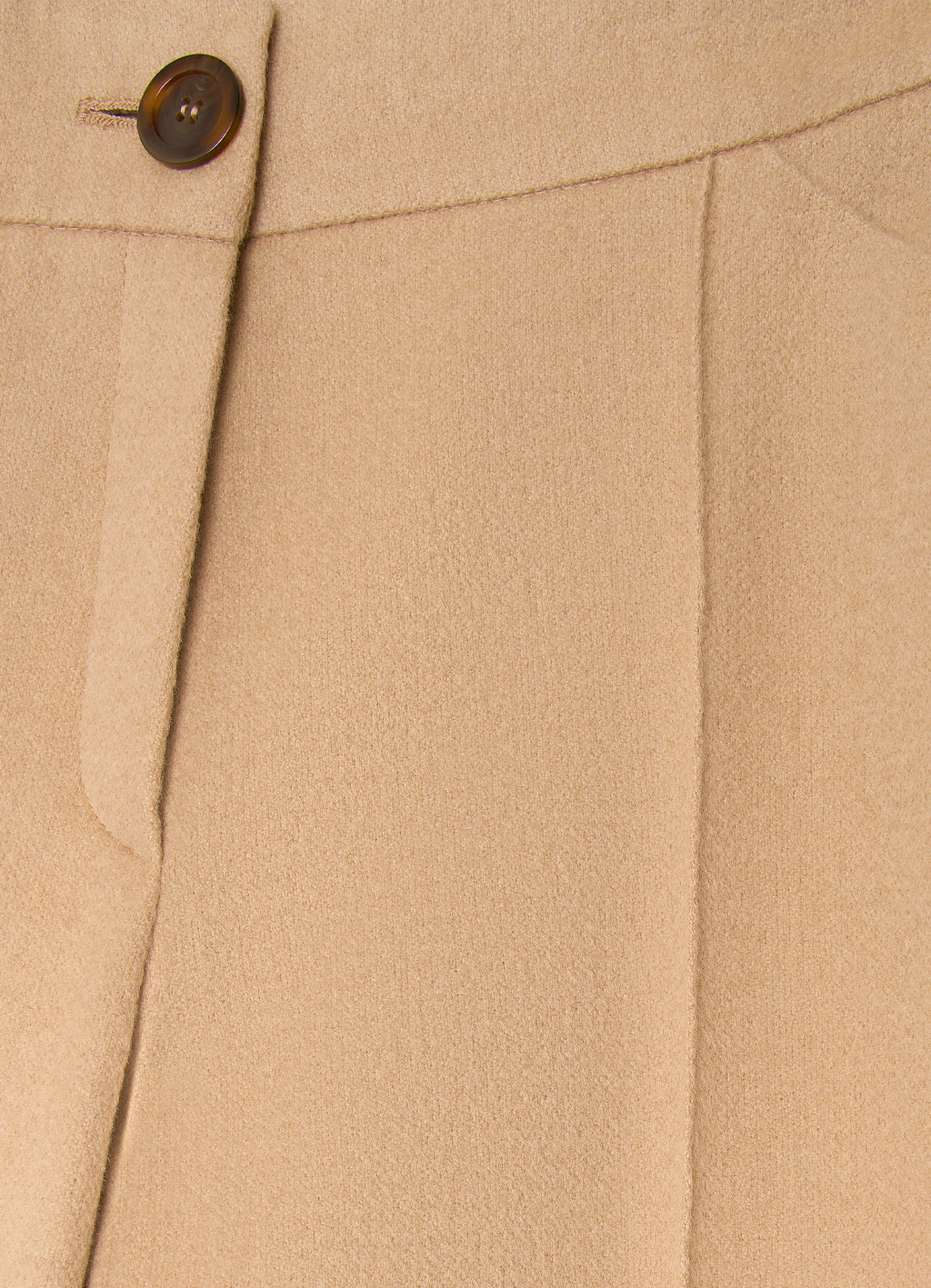 Detail of camel wool-cashmere trousers showing tailored waistband, button fastening and soft structured fabric
