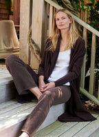 Cream sleeveless top styled under knitwear with relaxed tailoring