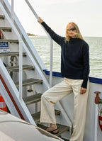 Straight-leg tailored trousers with cuffs styled with a cashmere knit on a ferry