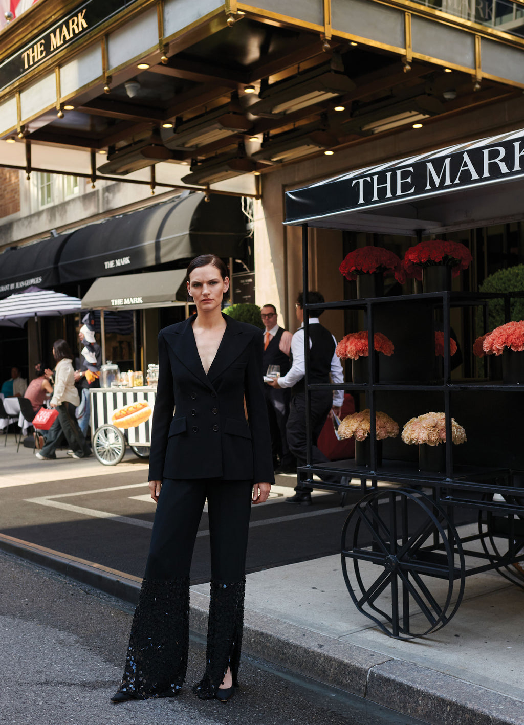 Black SCHOENBACH double-breasted blazer styled with sequin trousers. Featuring model Sophie Grace Hirsch in front of The Mark Hotel New York City