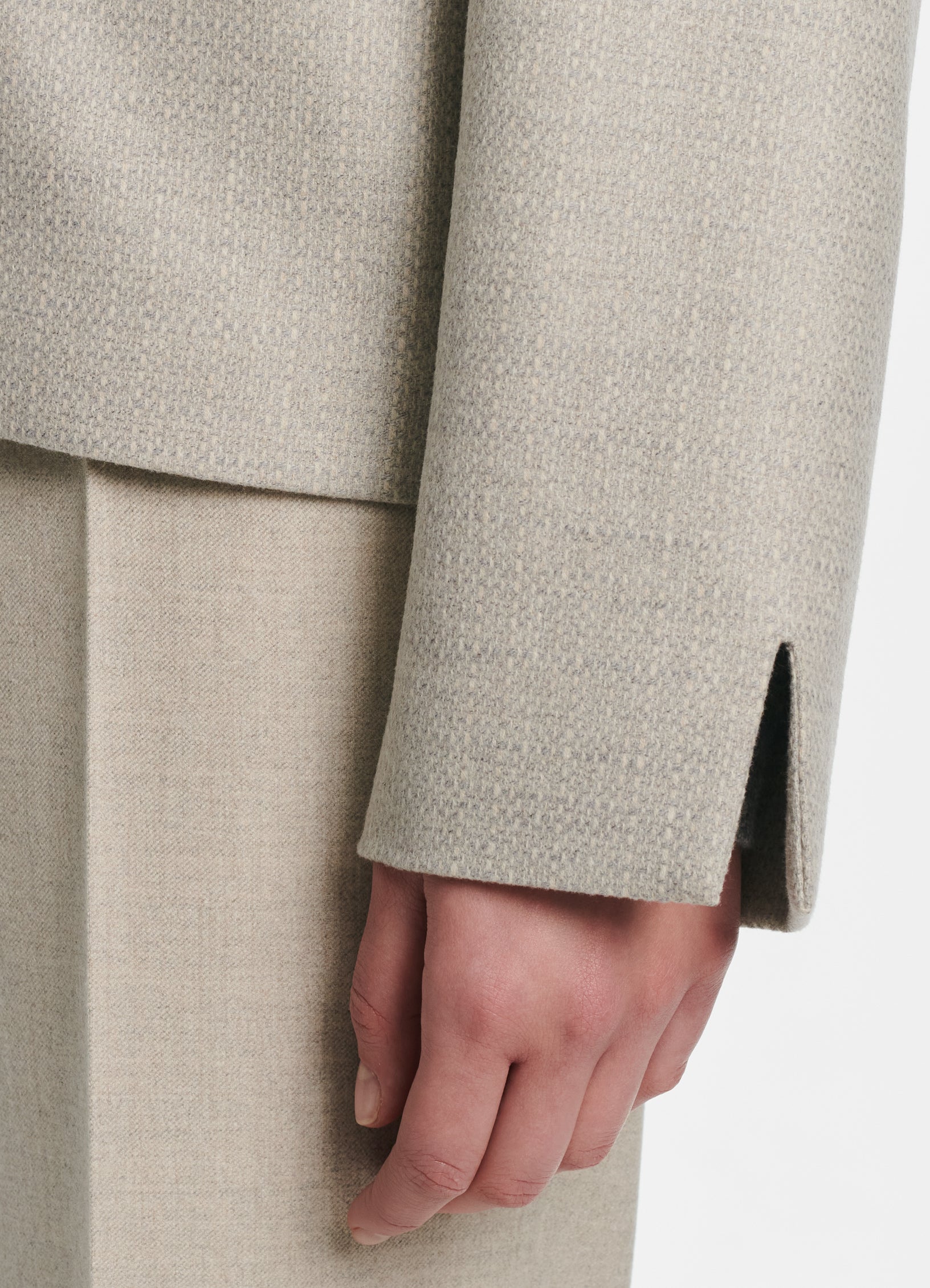 Detail of SCHOENBACH blazer cuff with clean straight sleeve finish in beige tailoring fabric