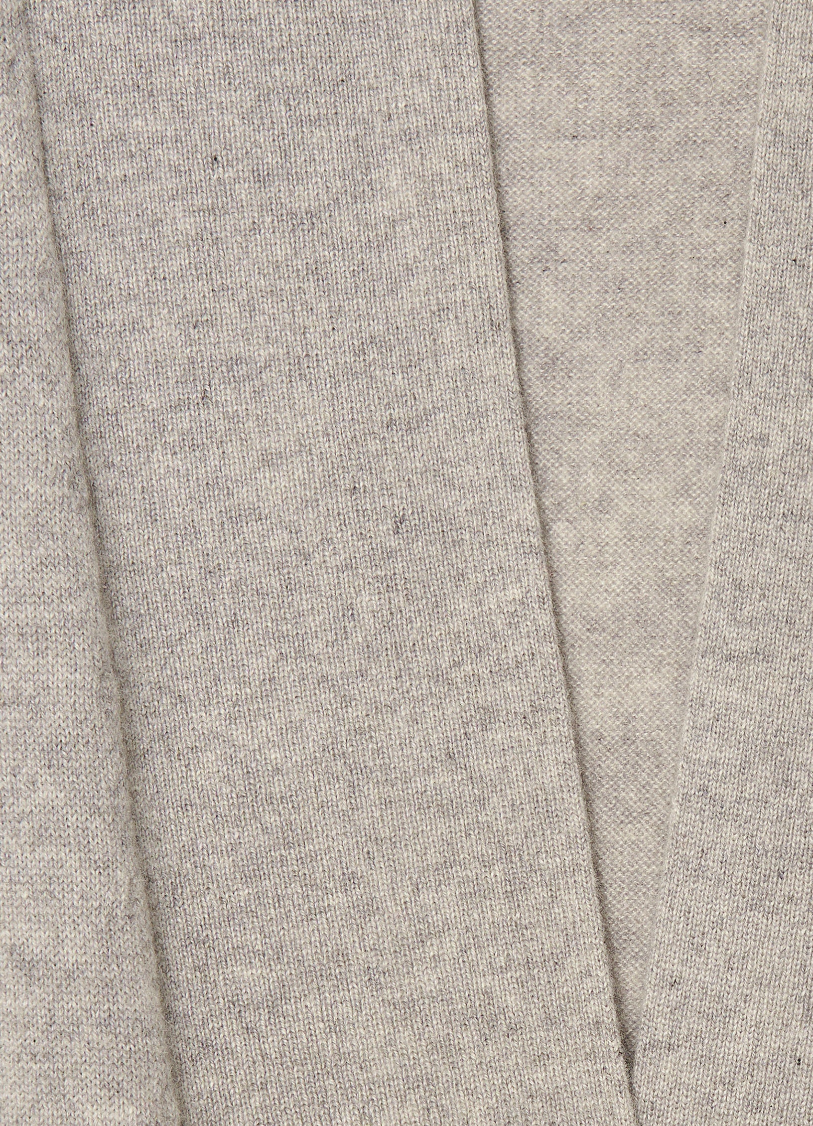 Close-up detail of the grey mélange cashmere knit texture and soft brushed finish.
