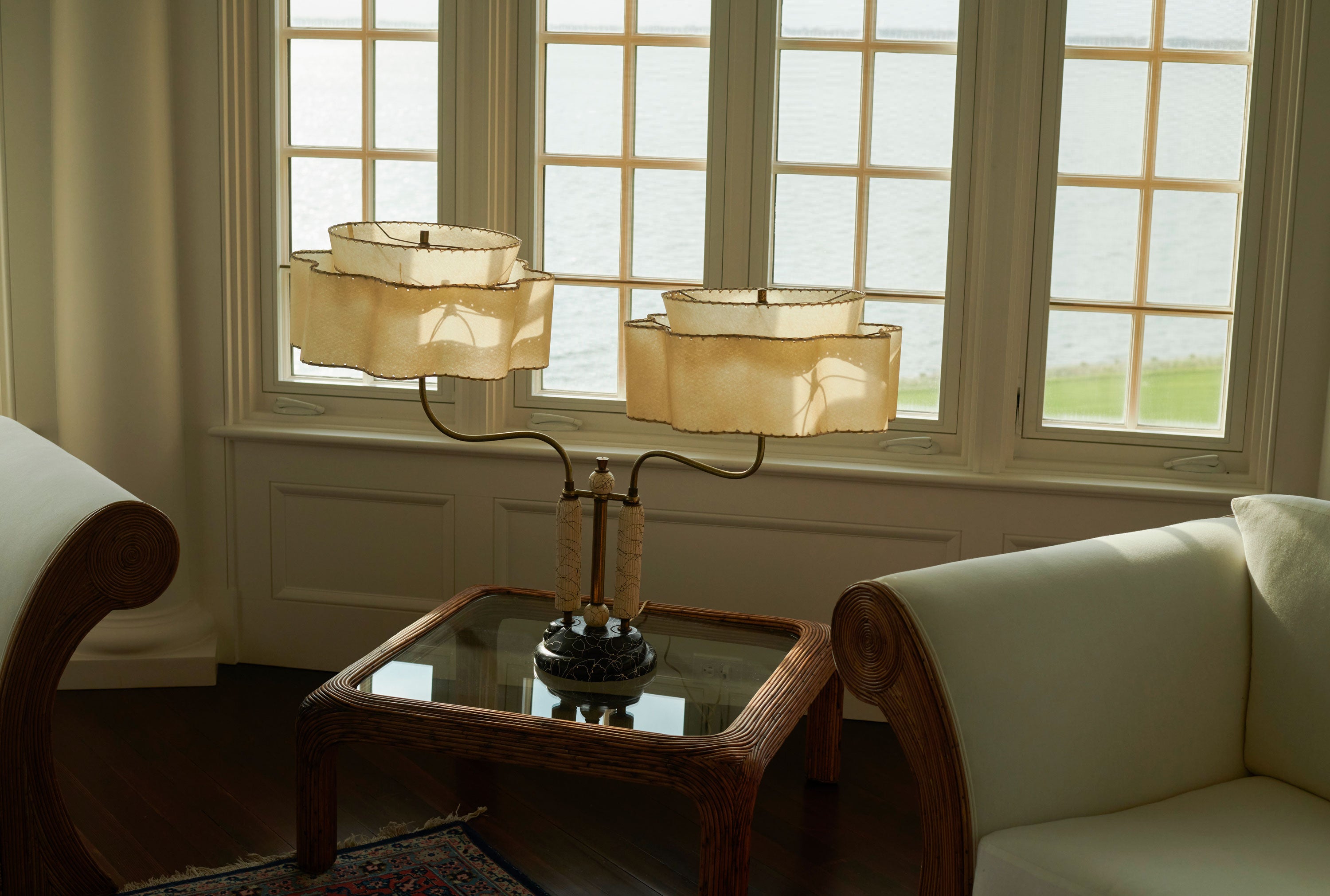 SCHOENBACH interiors bespoke design featuring a refined living room with sculptural lamps and natural light