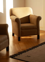 SCHOENBACH beige Hamptons armchair in a room with wooden floor and Nordic Knots Elder rug.