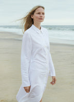 White midi shirt dress with classic collar, worn outdoors