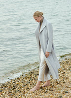Light grey wool-cashmere coat worn by the sea