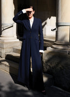 Model Sophie Grace Hirsch wearing SCHOENBACH virgin wool coat in front of a New York City townhouse 