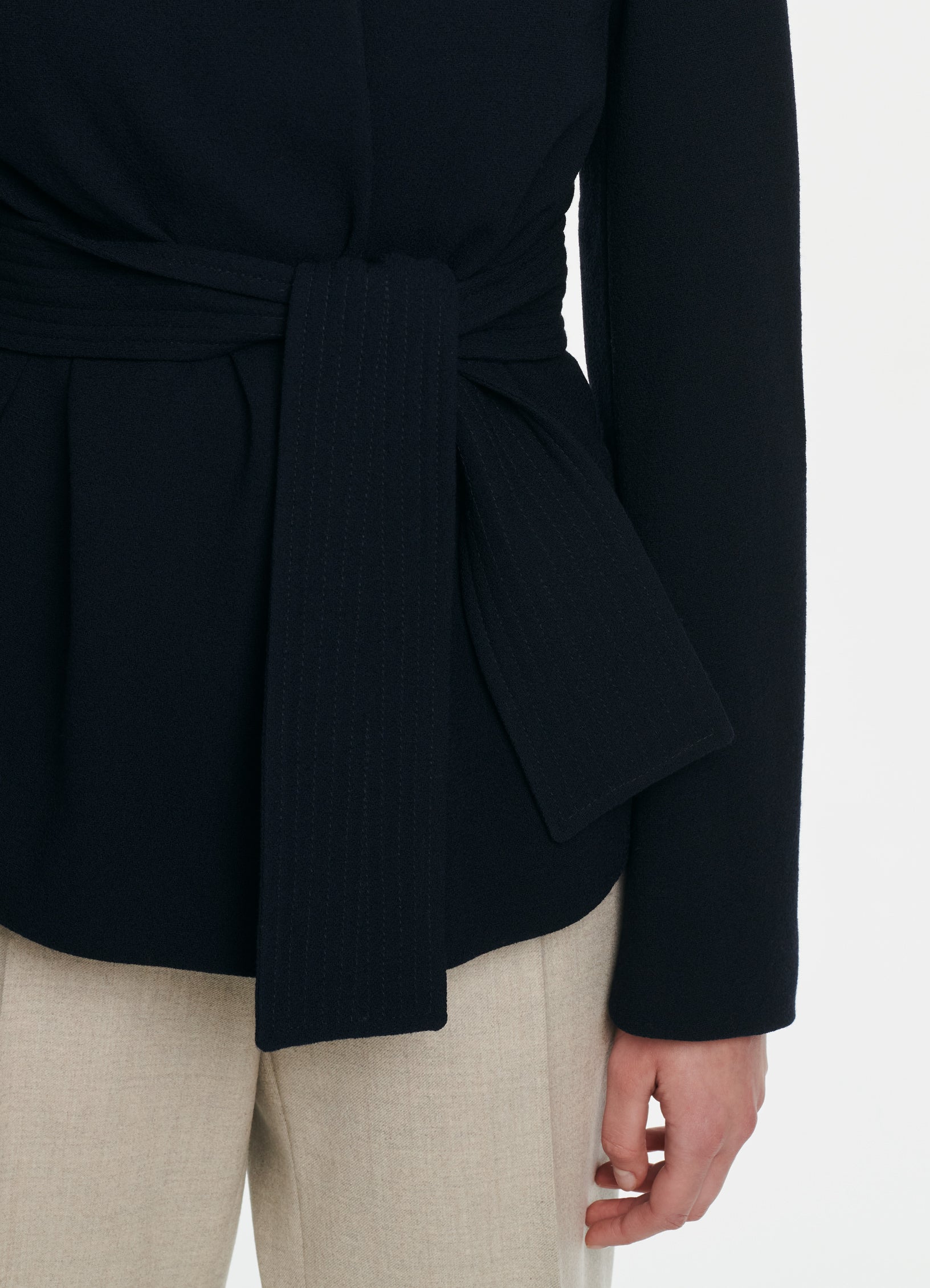 Close-up of SCHOENBACH wrap jacket waist belt with stitch detailing in navy virgin wool