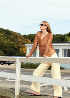Model Katrin Thormann wearing SCHOENBACH ozelot print silk blouse with ivory trousers in the Hamptons
