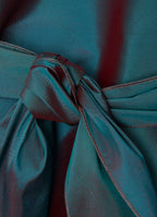 Silk taffeta wrap blouse in petrol detail showing crisp texture and tie fastening