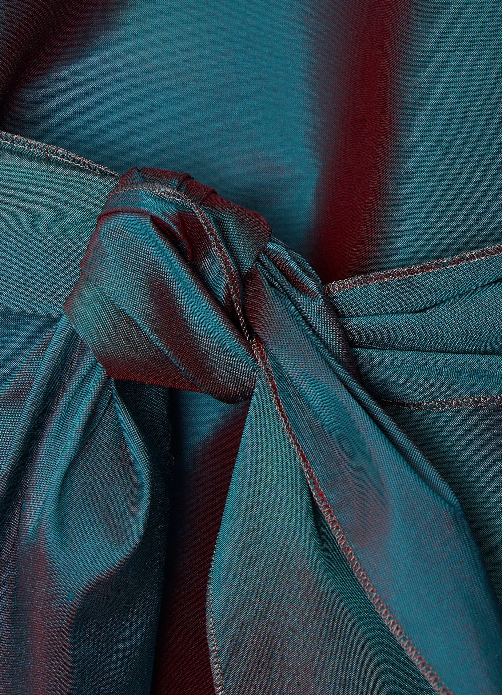 Silk taffeta wrap blouse in petrol detail showing crisp texture and tie fastening