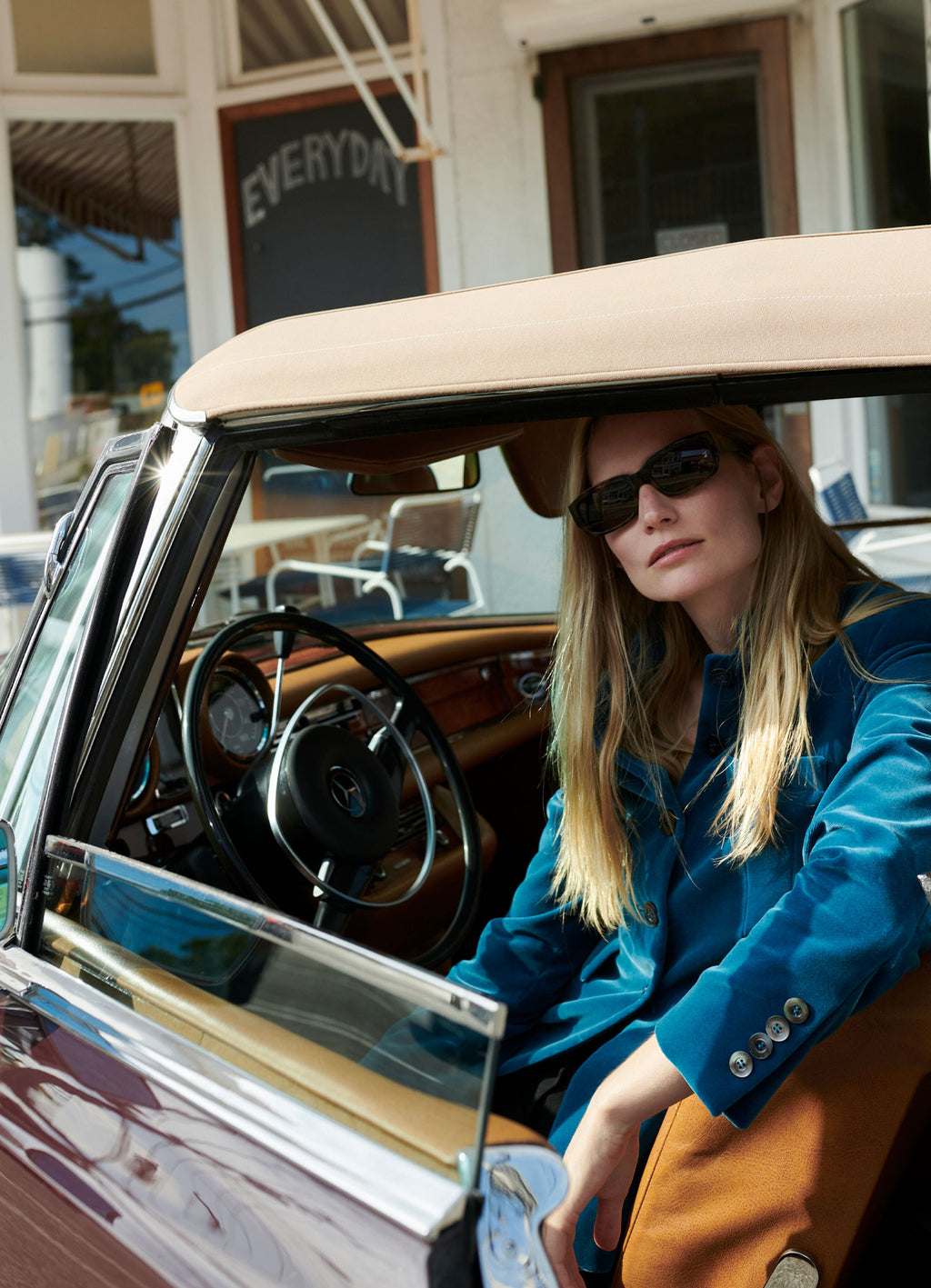 Petrol velvet jacket worn in vintage Mercedes car with structured silhouette and stand collar