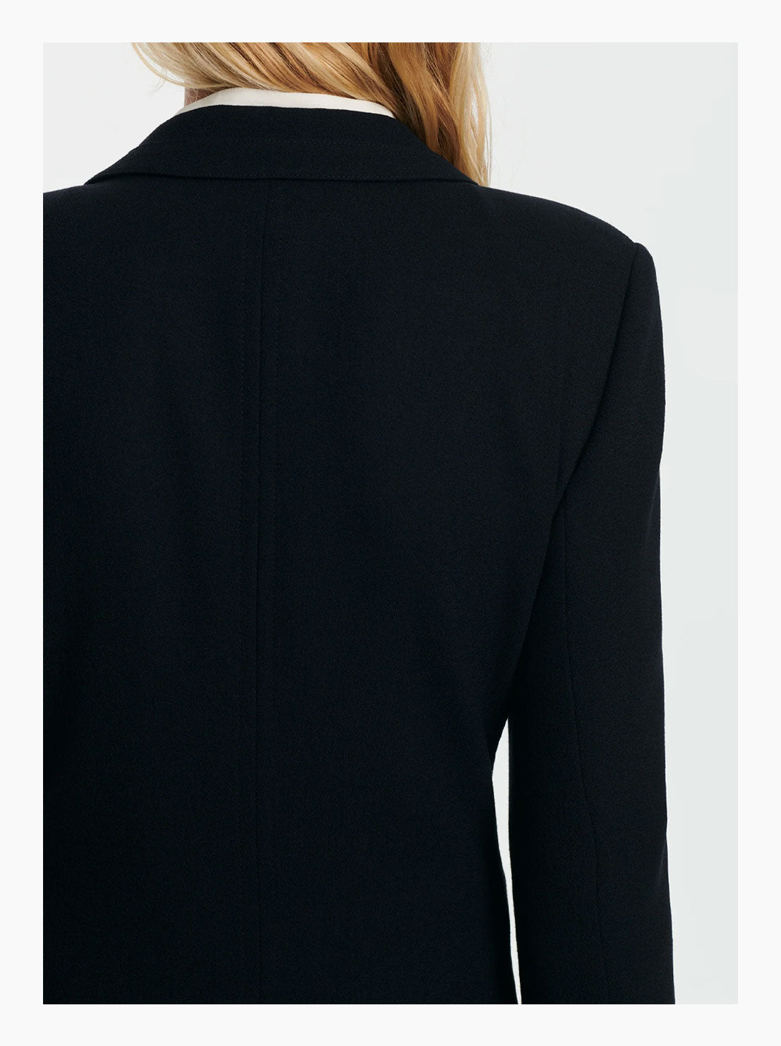 Virgin wool coat showing the back with a touch of white shirt collar