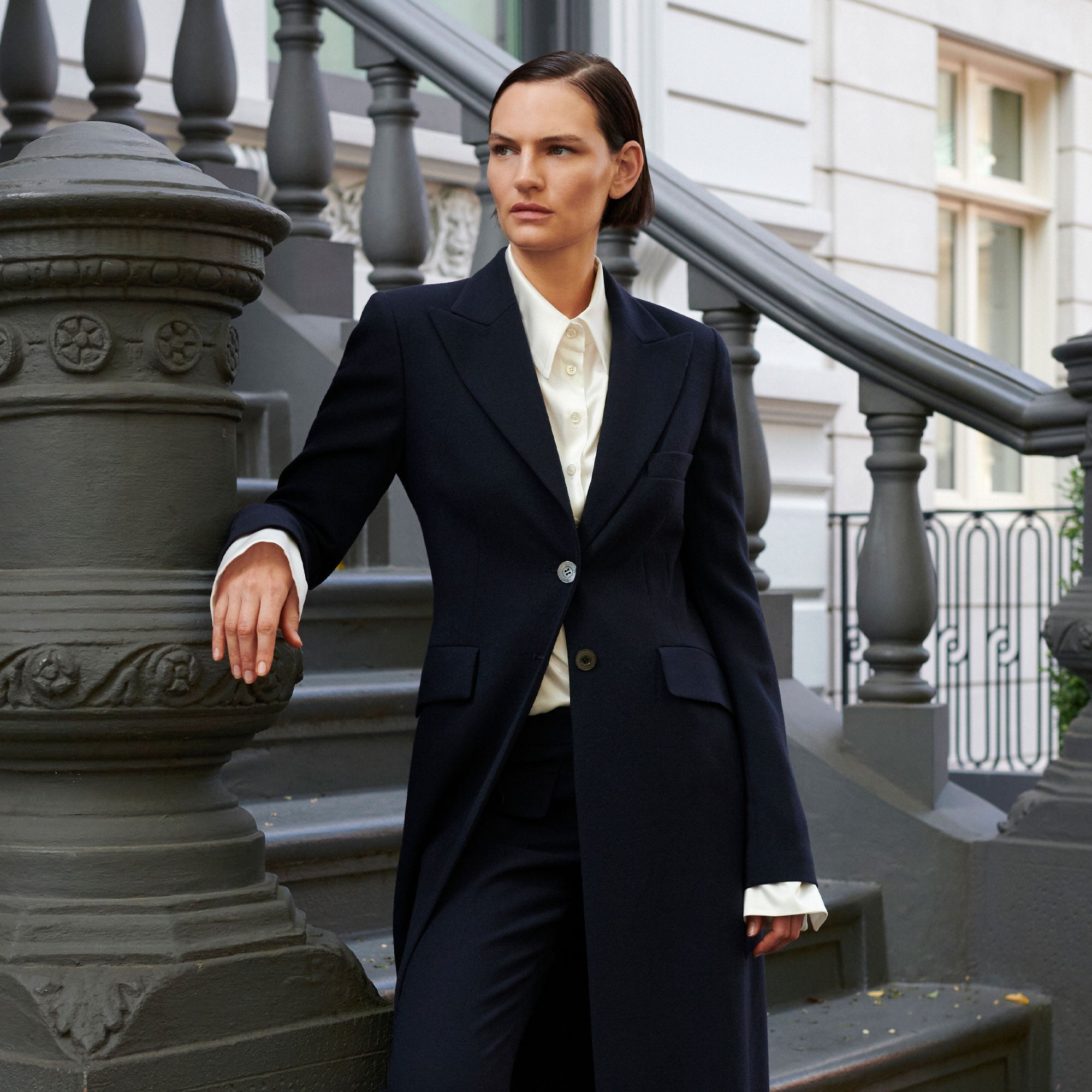 SCHOENBACH tailored womenswear featuring a structured suit in an architectural city setting