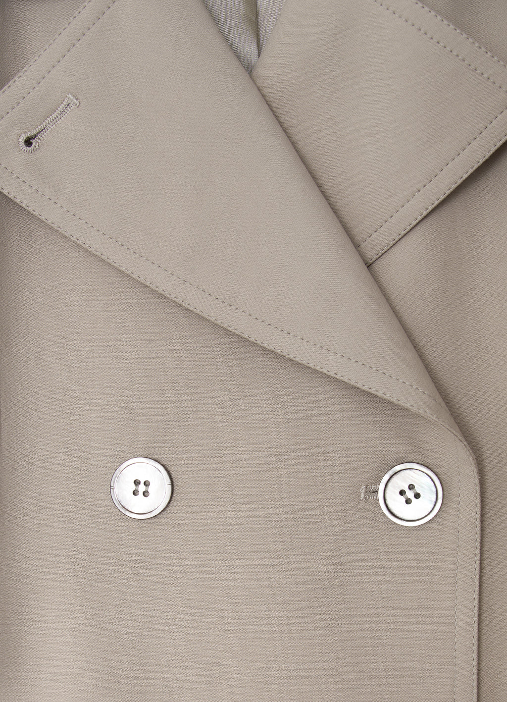 Taupe trench coat detail with mother-of-pearl buttons