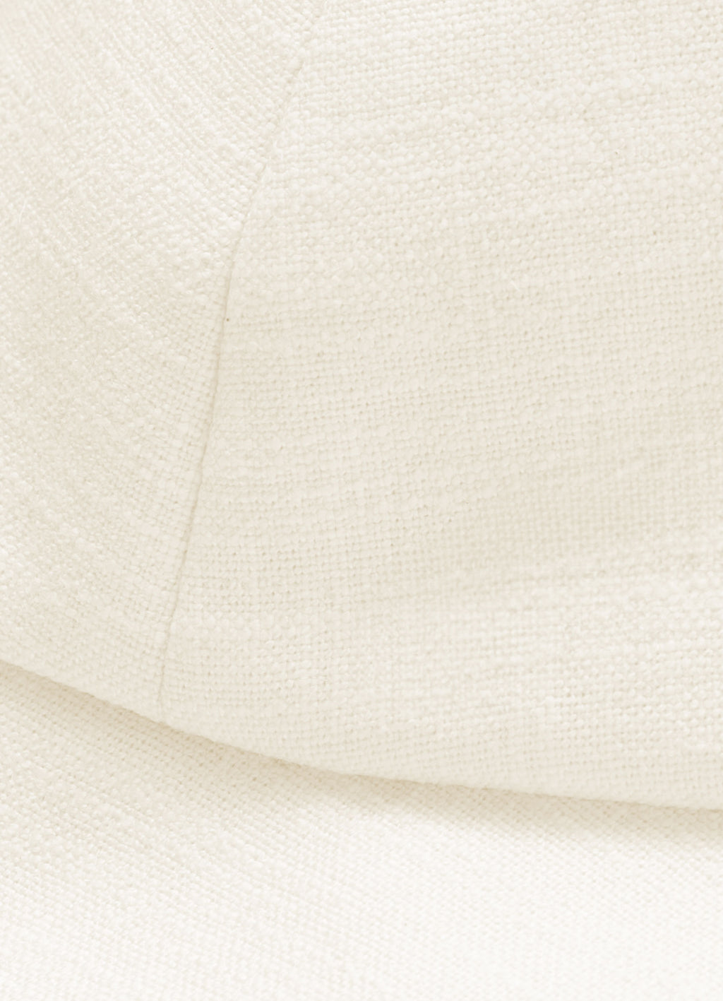 Close-up detail of textured linen cotton fabric on structured white sun hat