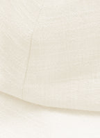 Close-up detail of textured linen cotton fabric on structured white sun hat
